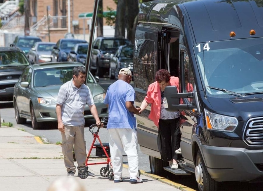 Fairview Adult Day Care staff helping elderly with transportation