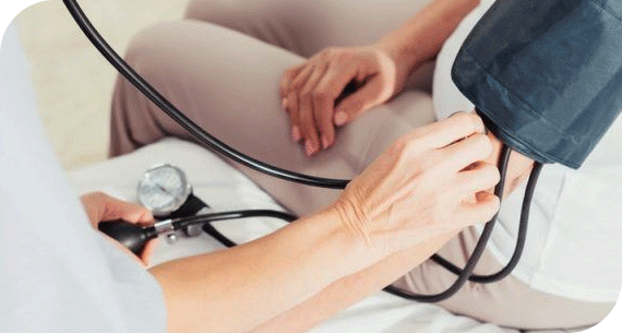 Nurse checking blood pressure of a patient