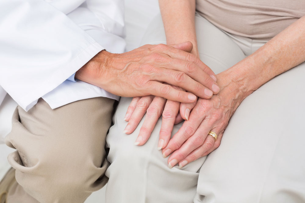 Doctor giving Psychotherapy to a senior patient holding his hands