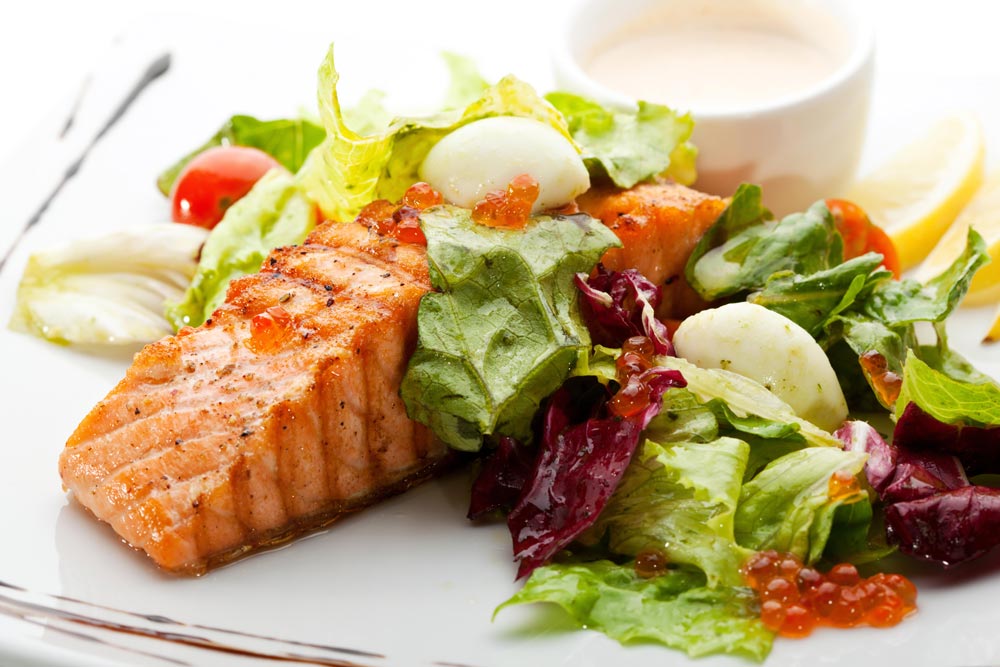 Salmon steak served with fresh salad - brain food