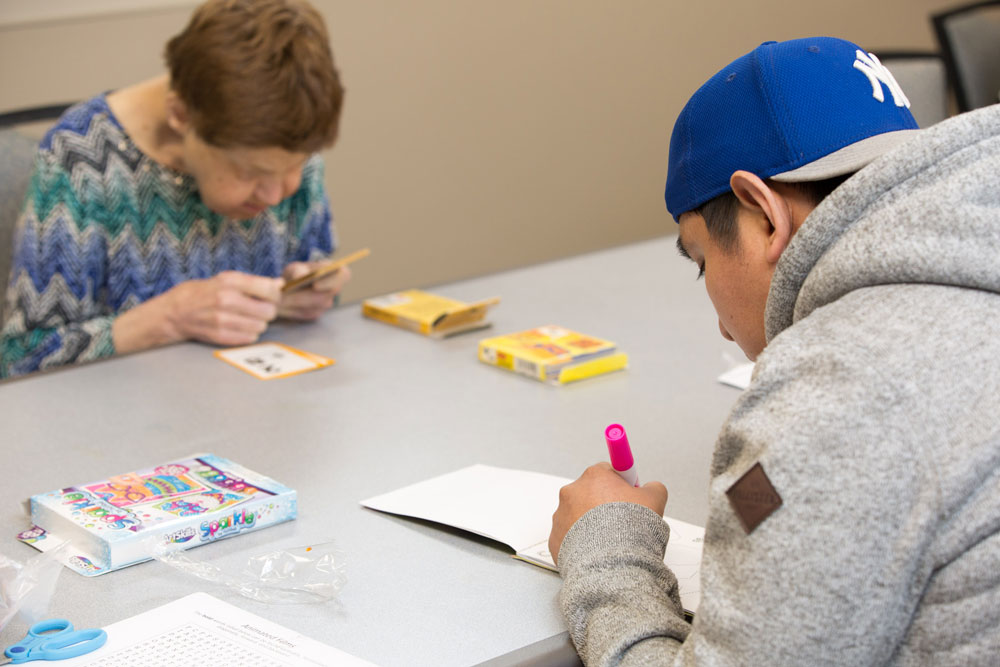 Elderly women and a young boy doing mental exercises to recover from TBI