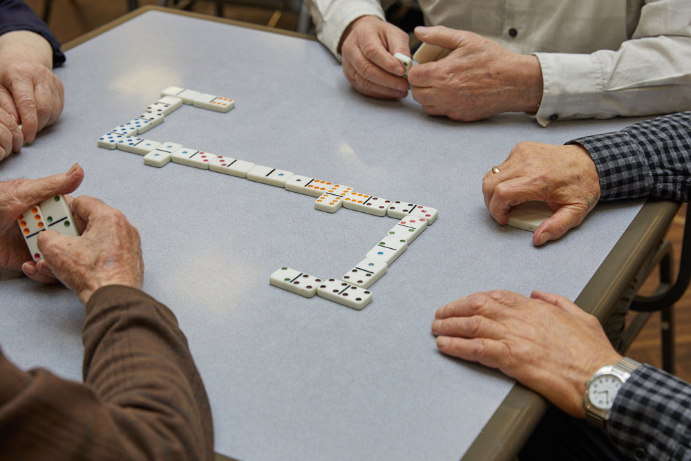 Senior adults playing domino game to improve memory