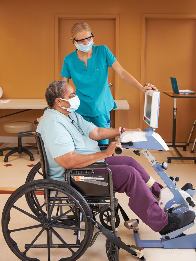 Nurse measuring heart rate of a senior woman sitting on a wheel chair going through heart problems due to cardiovascular changes.
