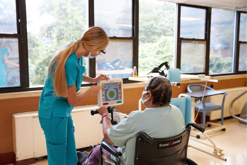 Nurse providing Geriatric Rehabilitation to an elderly woman.
