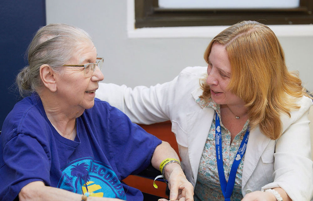 Therapist helping elderly woman with Speedy Health Deterioration.