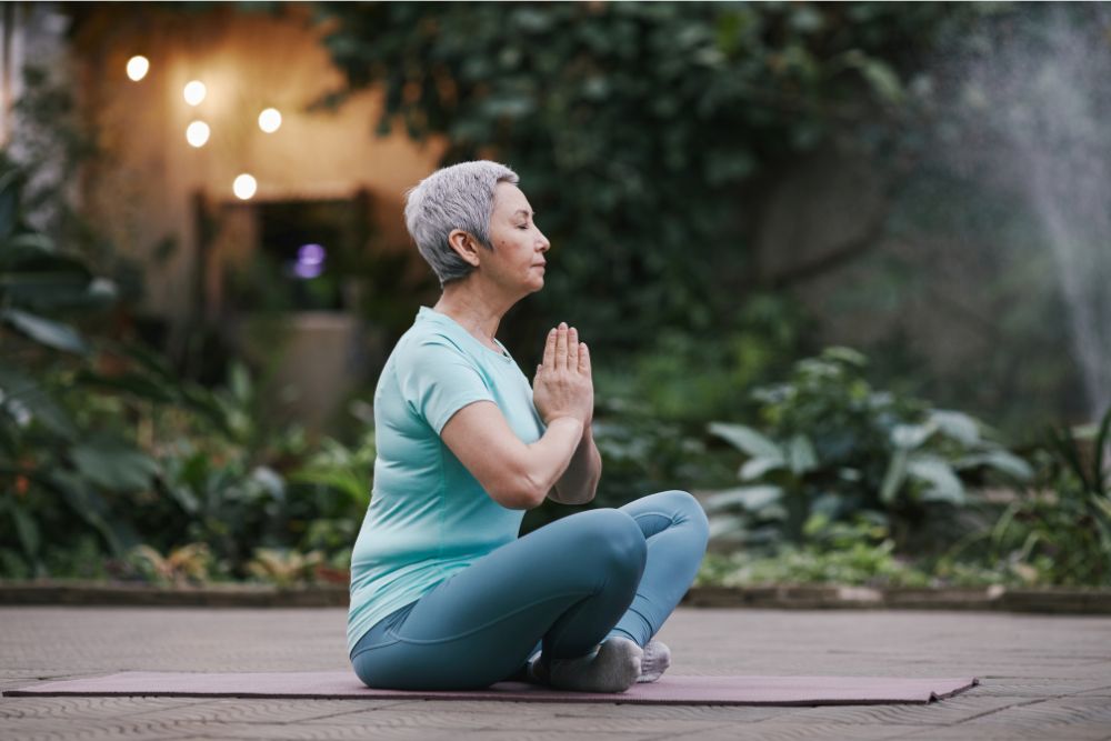 Elderly woman doing yoga for neurological conditions
